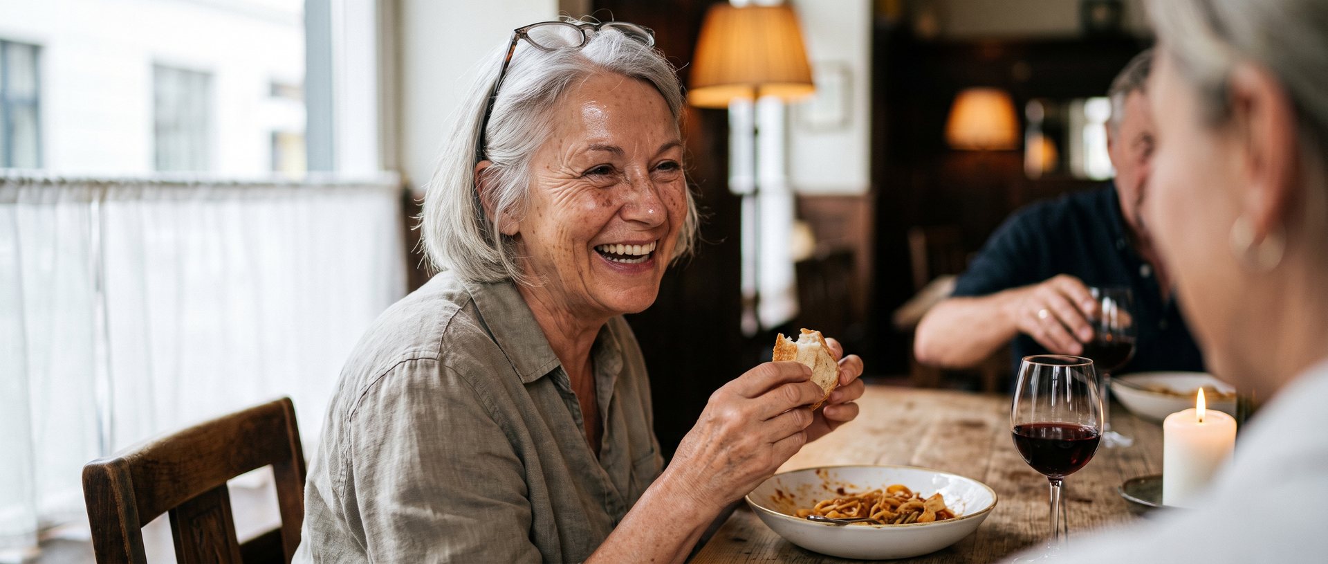 AI-generated illustration of a woman in her sixties laughing at a dinner table with friends